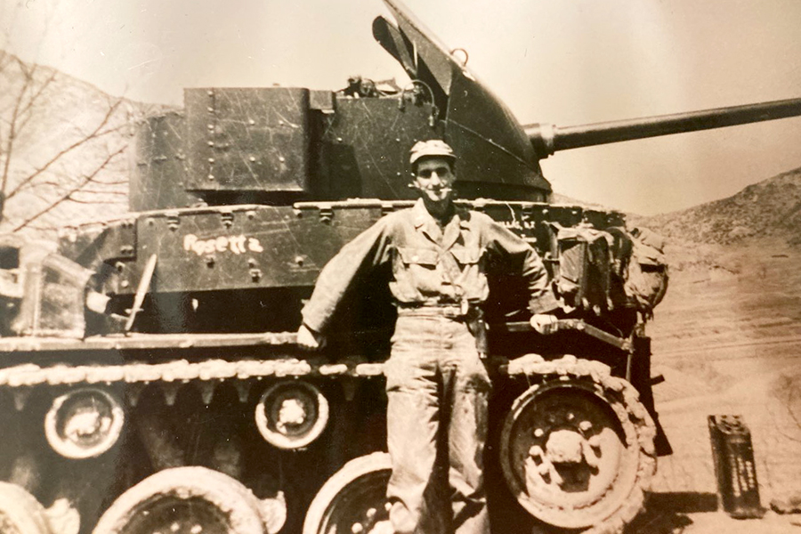 Photo of Col. Dr. Edmund “Ed” A. Krekorian standing in front of a tank in the Korean War